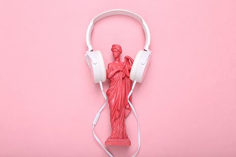 antica statua greca con le cuffie su uno sfondo rosa